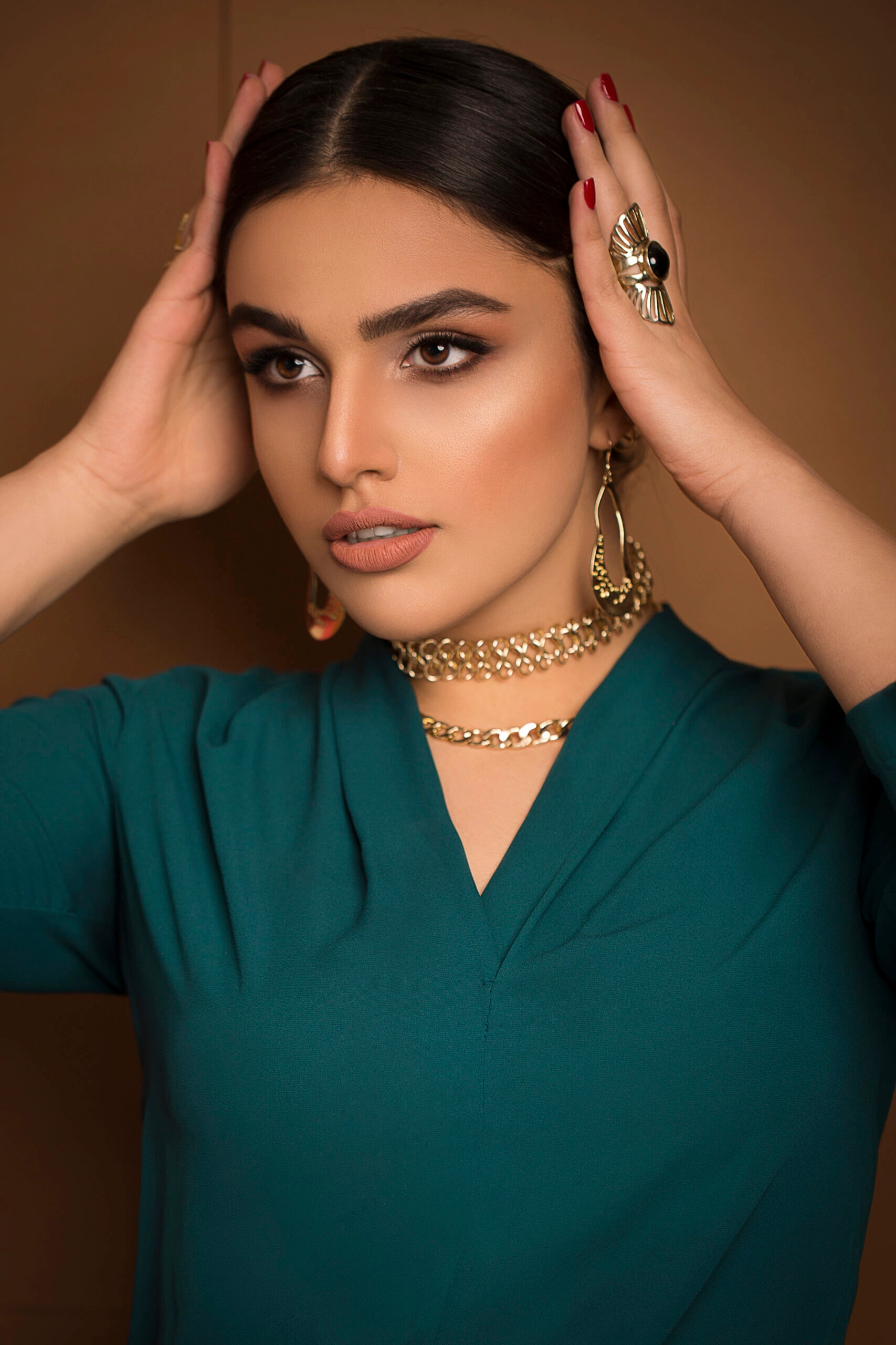 Model wearing gold chain necklaces