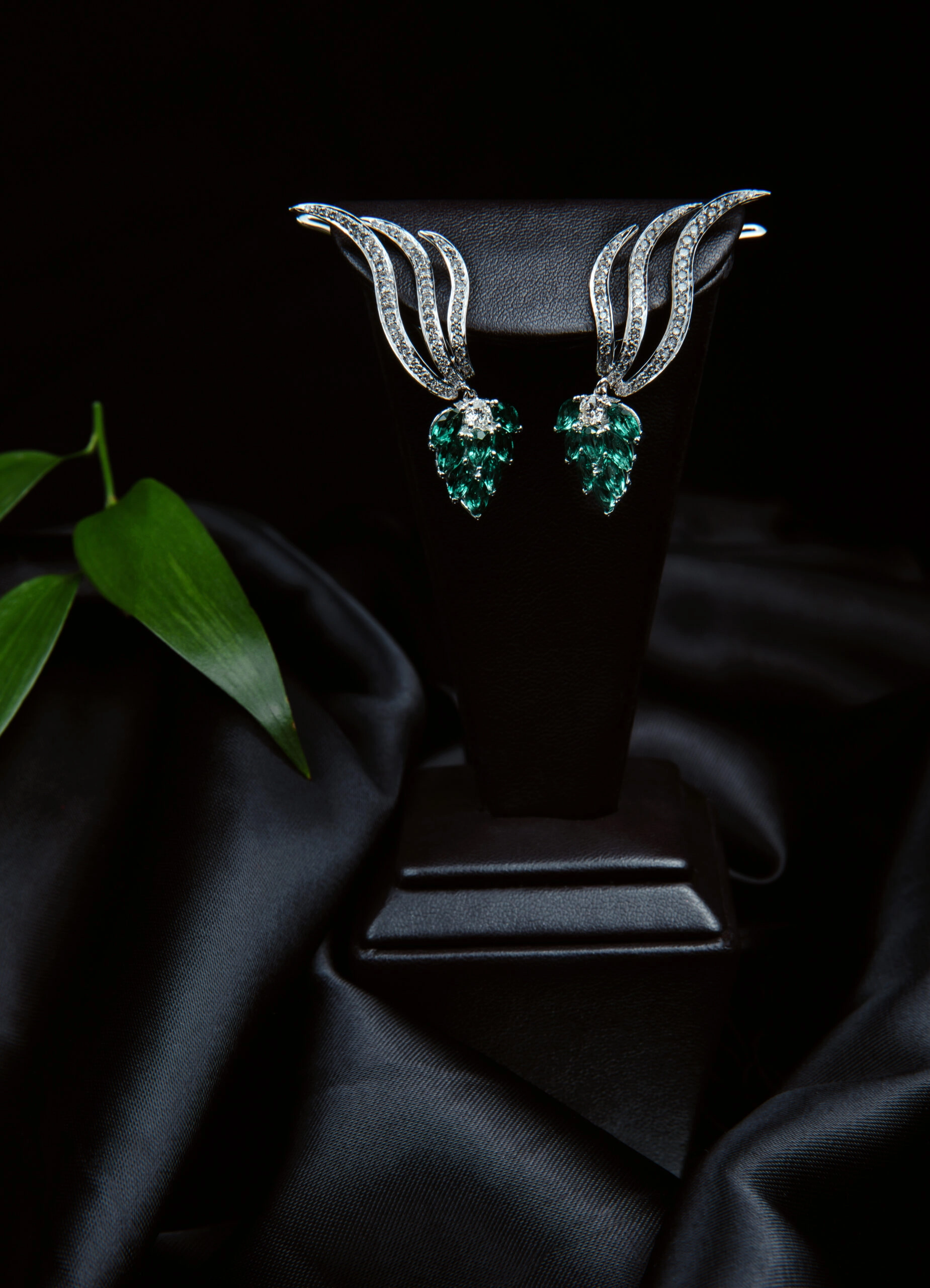 Silver diamond earrings with emeralds