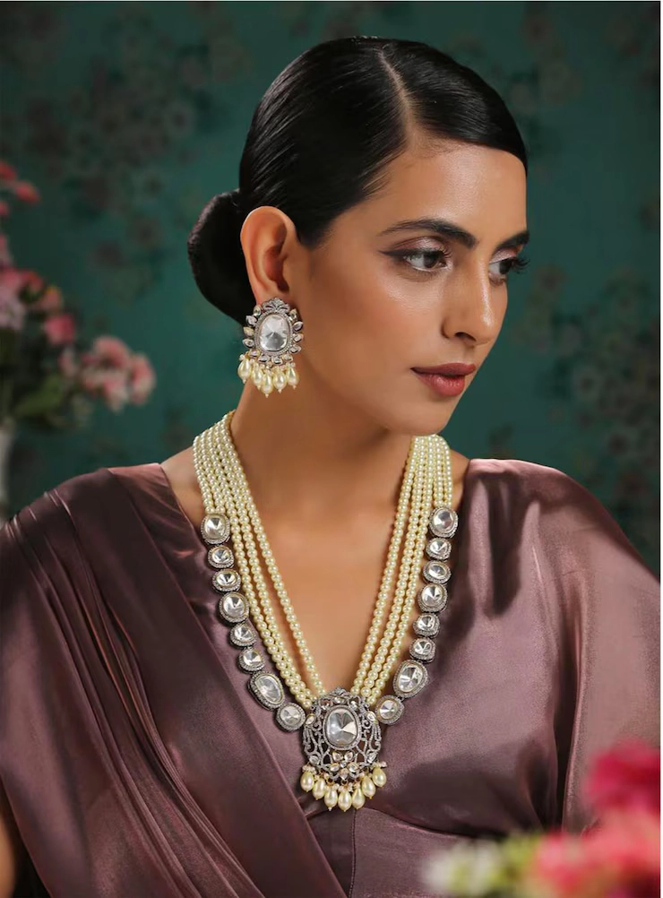 Woman wearing a large diamond necklace and earrings